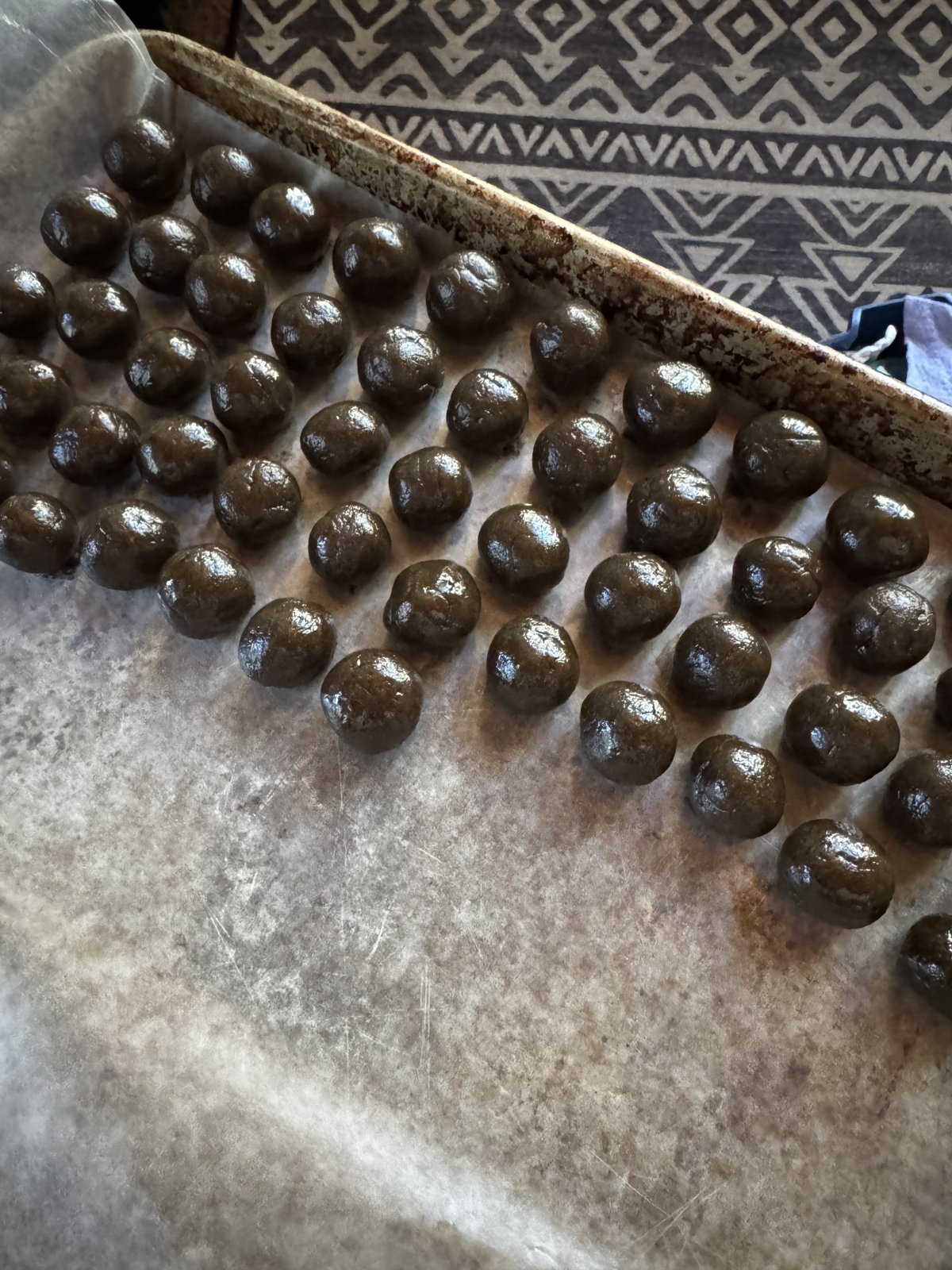Hand-rolled date truffle centers resting on parchment